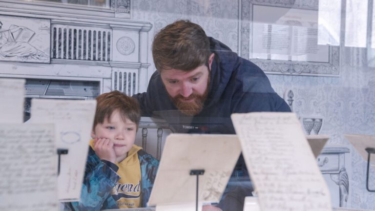 A man and boy looking at a display in Strokestown National Famine Museum.