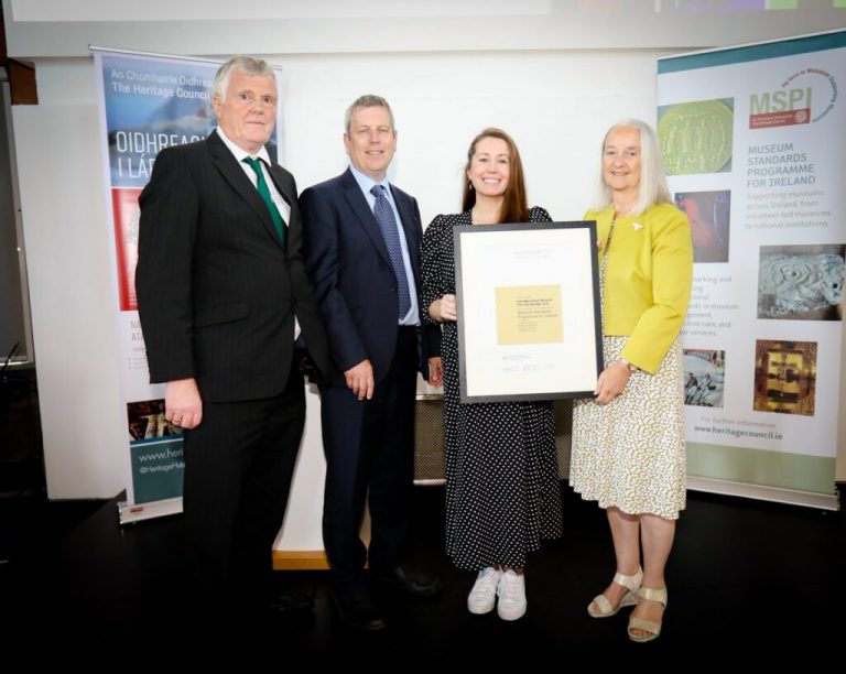 A group of people at the presentation of a "Full Museum Standards" award.